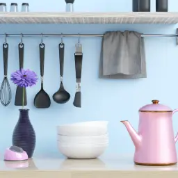 a kitchen counter with utensils and a tea pot